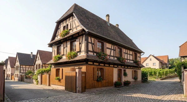 Photographie réaliste d'un bâtiment résidentiel typique de Marlenheim en Alsace, montrant une architecture locale caractéristique du Bas-Rhin avec des éléments architecturaux régionaux distinctifs. La photo doit être prise de jour en lumière naturelle, présentant une propriété bien entretenue dans son contexte urbain ou péri-urbain local. L'image doit être de qualité professionnelle, sans texte, logo ou filigrane visible, et représenter le cadre de vie où l'entreprise de rénovation intervient.